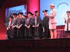 Students collect their certificates.